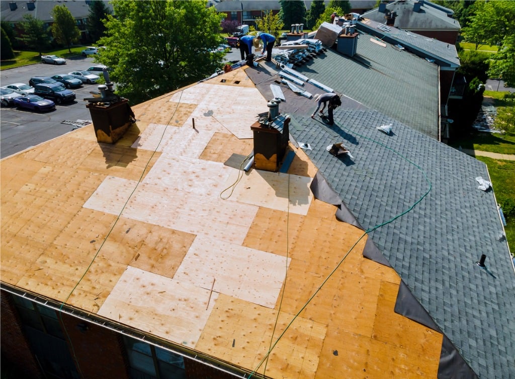 Image of a roof with no covering showing the plywood sheathing deck